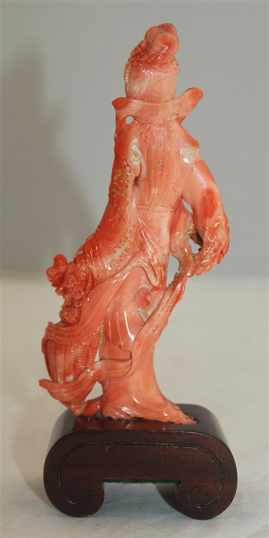 A Chinese coral figure of a beautiful lady holding a basket of flowers, 17.5cm incl. wood stand